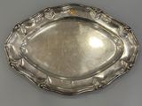 a silver plate with a decorative design on the edge