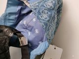 a purse and a purse tag sitting on a table