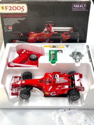 une petite voiture de course rouge dans une boîte posée sur une table