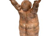 statue of a child holding his hands up in the air
