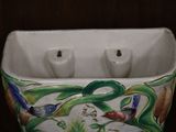 a white vase with a bird design on it