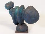a sculpture made of blue and green rocks on a wooden base