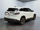 the rear view of a white suv parked in a garage