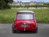 a small red car that is parked on the side of the road