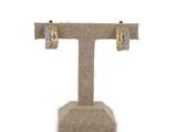a close up of a pair of earrings on a stand