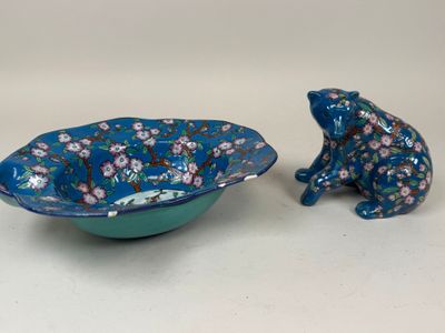 two small blue and green bowls with a frog figurine in the middle