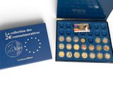 a blue box filled with coins sitting on top of a white surface