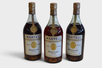 three bottles of wine sitting next to each other on a white surface