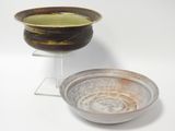 a brown and white bowl and a brown and white bowl on a stand