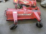 two red tractors that are sitting on the ground