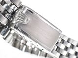 a close up of a watch on a white surface