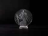 a clear glass figurine of a person holding a cross
