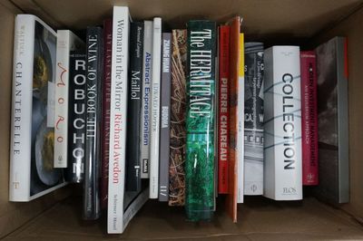 many books that are in a box on the table