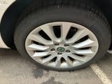 a close up of a tire on a car in a parking lot