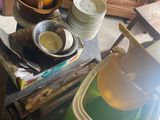 a pile of dirty dishes and dishes on the kitchen counter