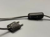 a black cord connected to a black device on a table