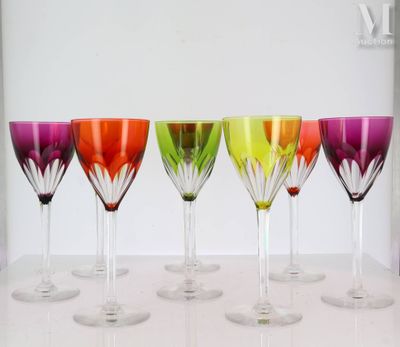 six wine glasses are lined up in a row on a table