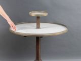 a woman standing next to a table with a cake on it