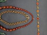 several different types of beads and chains laid out on a table