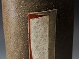 a close up of a vase with a red stripe on it