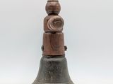 an old bell is sitting on a white surface with a white background