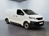 the white van is parked in the large room of the building