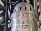 a metal bucket that is sitting inside of a metal container