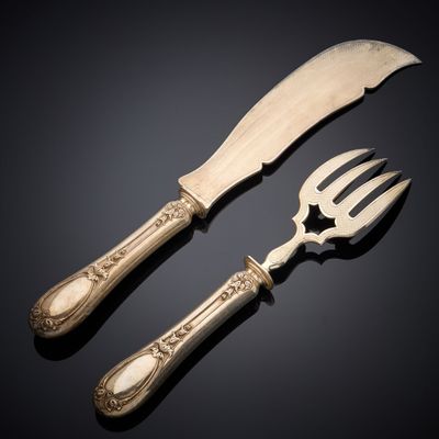 pair of silverware with a knife and a fork on a black surface