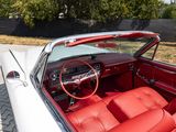 a red and white convertible car parked on the side of the road
