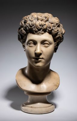 a marble bust of a woman with curly hair