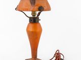 an old fashioned lamp with a cord plugged to it ' s base