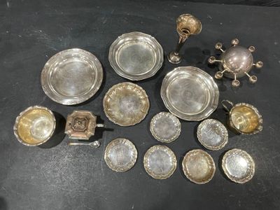 a lot of silver dishes on a black table