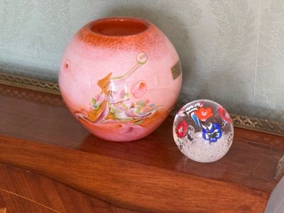 un vase et une boule de verre posés sur une étagère