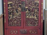 a red cabinet in a room with a wooden floor