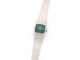 a close up of a wrist watch on a white surface
