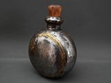 an image of a metal flask with a wooden stopper