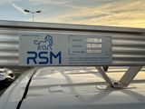 a sign on the roof of a car that says rsm