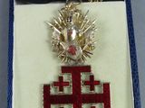 an image of a cross with a crown on it in a box