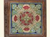 a picture of a decorative tile with flowers and leaves