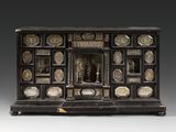 a black and gold cabinet with ornate carvings on the front