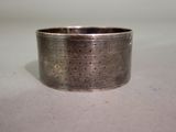 a silver ring with holes in it on a table