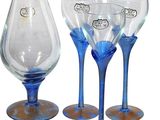 four wine glasses and a decanter on the table