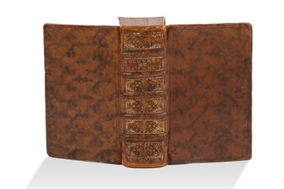 un vieux livre à la couverture brune posé sur une surface blanche