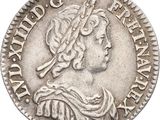 a close up of a silver coin with a woman on it