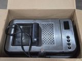 a microwave sitting in a box with a cord attached to it