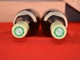 two bottles of wine that are sitting on a table
