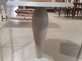 a white table with a glass top in a room