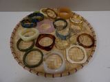 many different rings and bracelets sitting on a tray