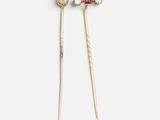 a pair of gold and diamond hair pins