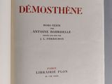 an open book on a table with the title demoosthene written in red